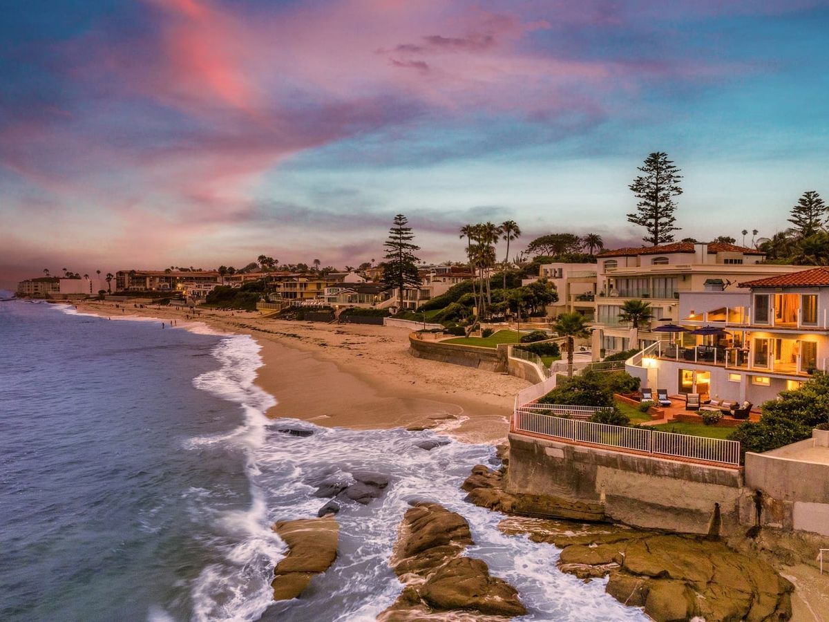 This luxury beachfront home sits right on the sand with waves crashing below and a glowing sunset sky above. Playa Vista Beachfront offers front-row ocean views, private patios, and the perfect backdrop for a dreamy coastal escape.