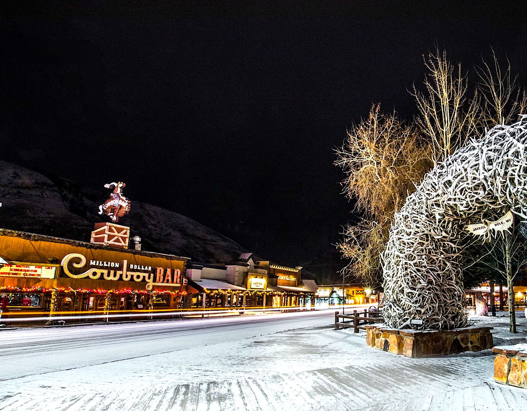 Jackson Hole, WY downtown boardwalk area and antler arch at night in the winter. 