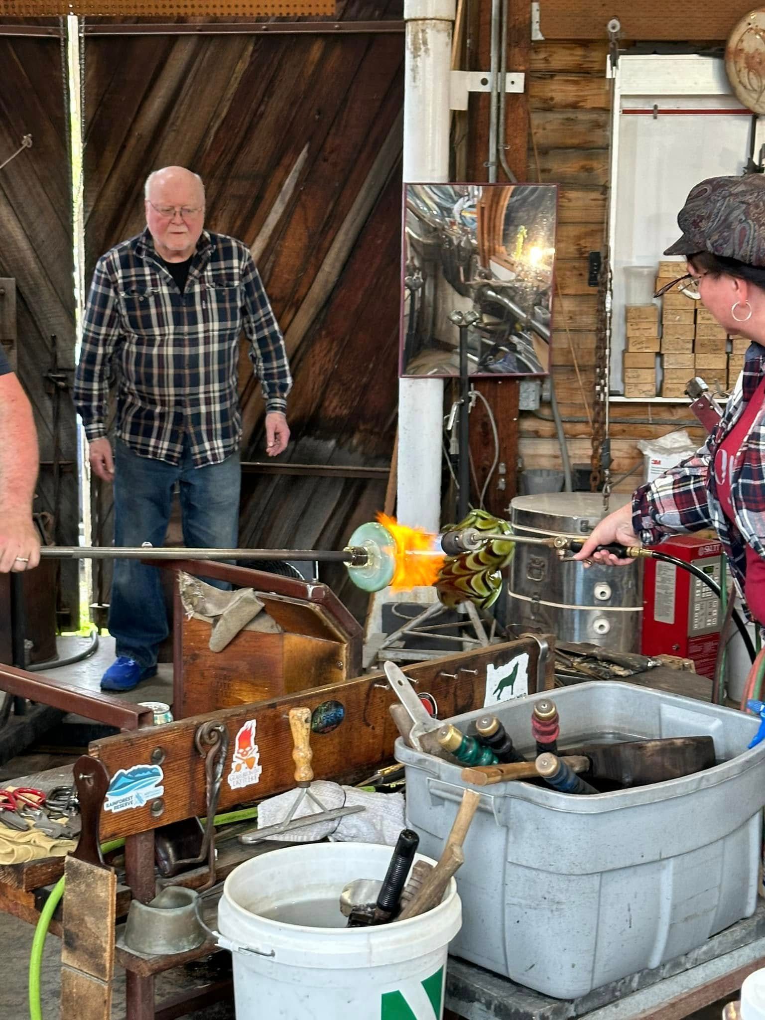 A live glassblowing demonstration at Icefire Glassworks, where an artist shapes molten glass using traditional tools and open flame. This hands-on experience gives you a close look at local craftsmanship and one of the most unique art studios to visit in Cannon Beach.