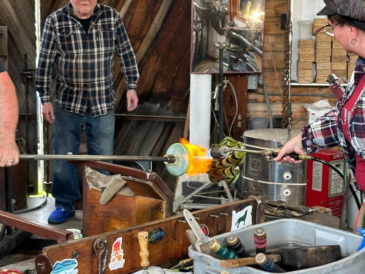 A live glassblowing demonstration at Icefire Glassworks, where an artist shapes molten glass using traditional tools and open flame. This hands-on experience gives you a close look at local craftsmanship and one of the most unique art studios to visit in Cannon Beach.