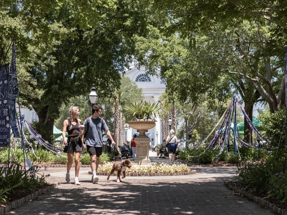 Couples and families stroll through the shady pathways of Magnolia Plantation & Gardens, enjoying the peaceful nature, history, and blooming landscapes.