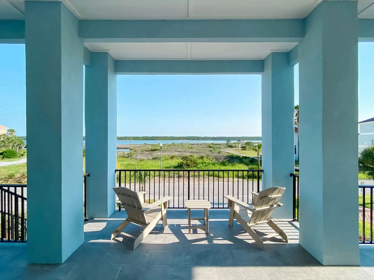 Gulf Shores Vacation Rental Front Porch with Chairs and View of Little Lagoon