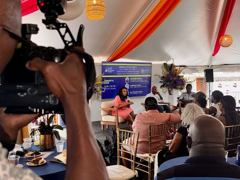A photographer captures a powerful panel discussion at the Martha’s Vineyard African American Film Festival. Under colorful draped tents, guests listen to inspiring conversations celebrating art, culture, and empowerment.