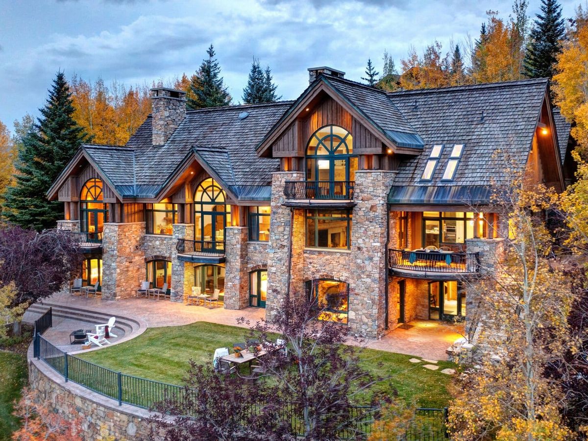 Large Park City rental with gated front yard and fall foliage trees surrounding it