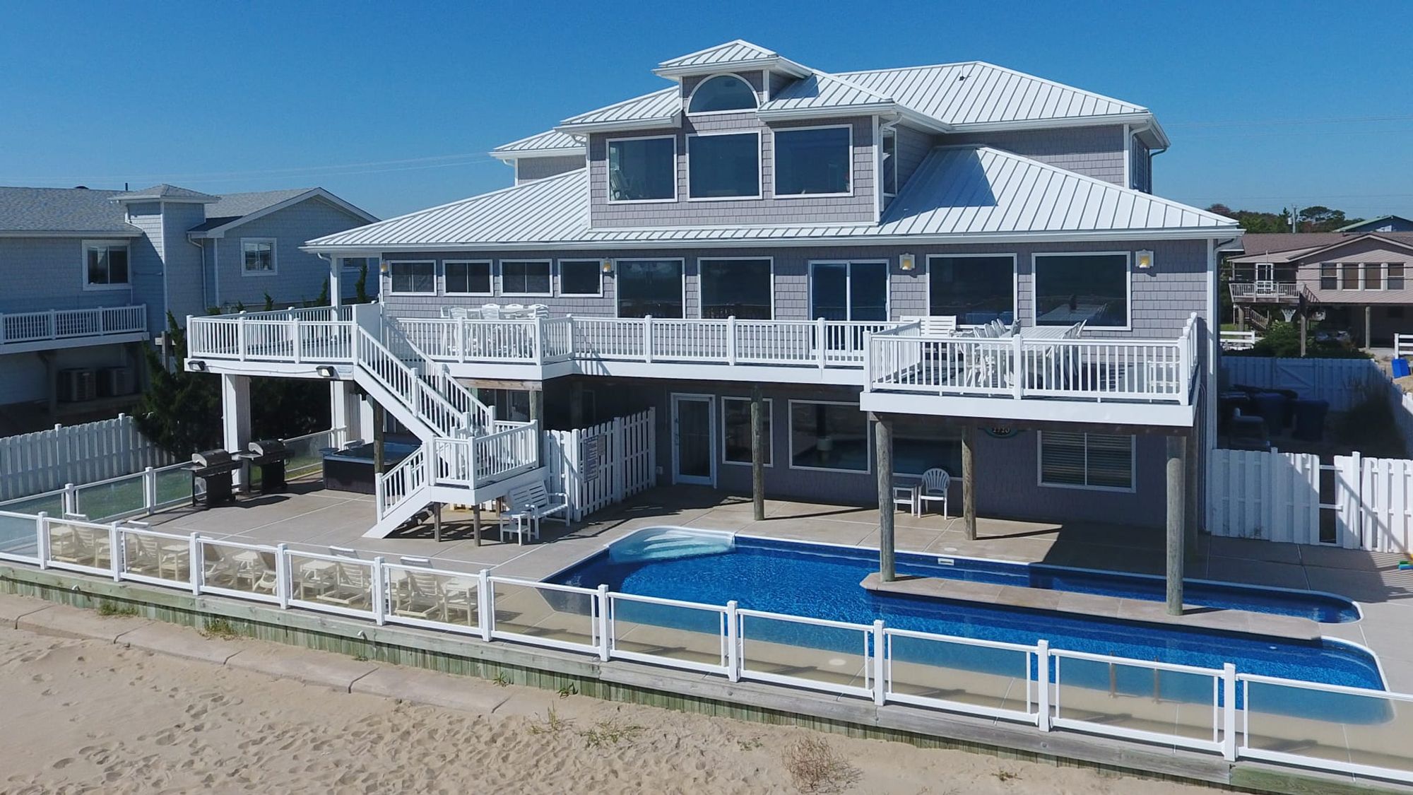 Elegant beachfront property with a private lap pool, multiple sun loungers, and spacious balconies. Ideal for large families or groups seeking a luxurious seaside getaway.