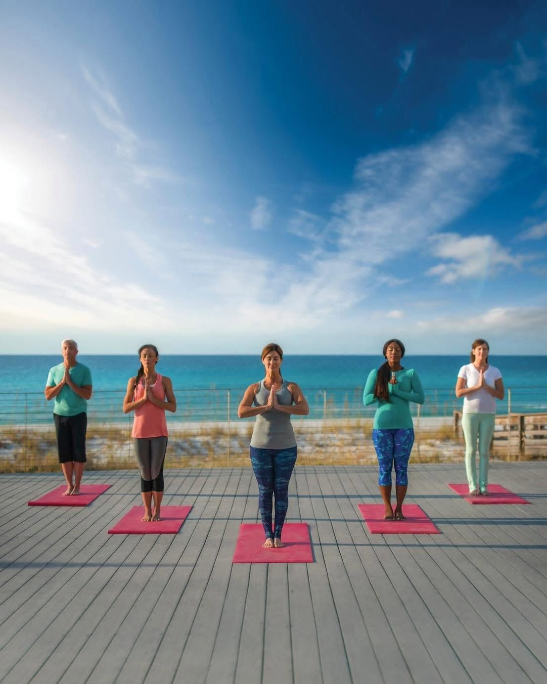 Beachfront outdoor yoga class at Serenity by the Sea Spa in Miramar Beach, Florida overlooking the Gulf of Mexico.