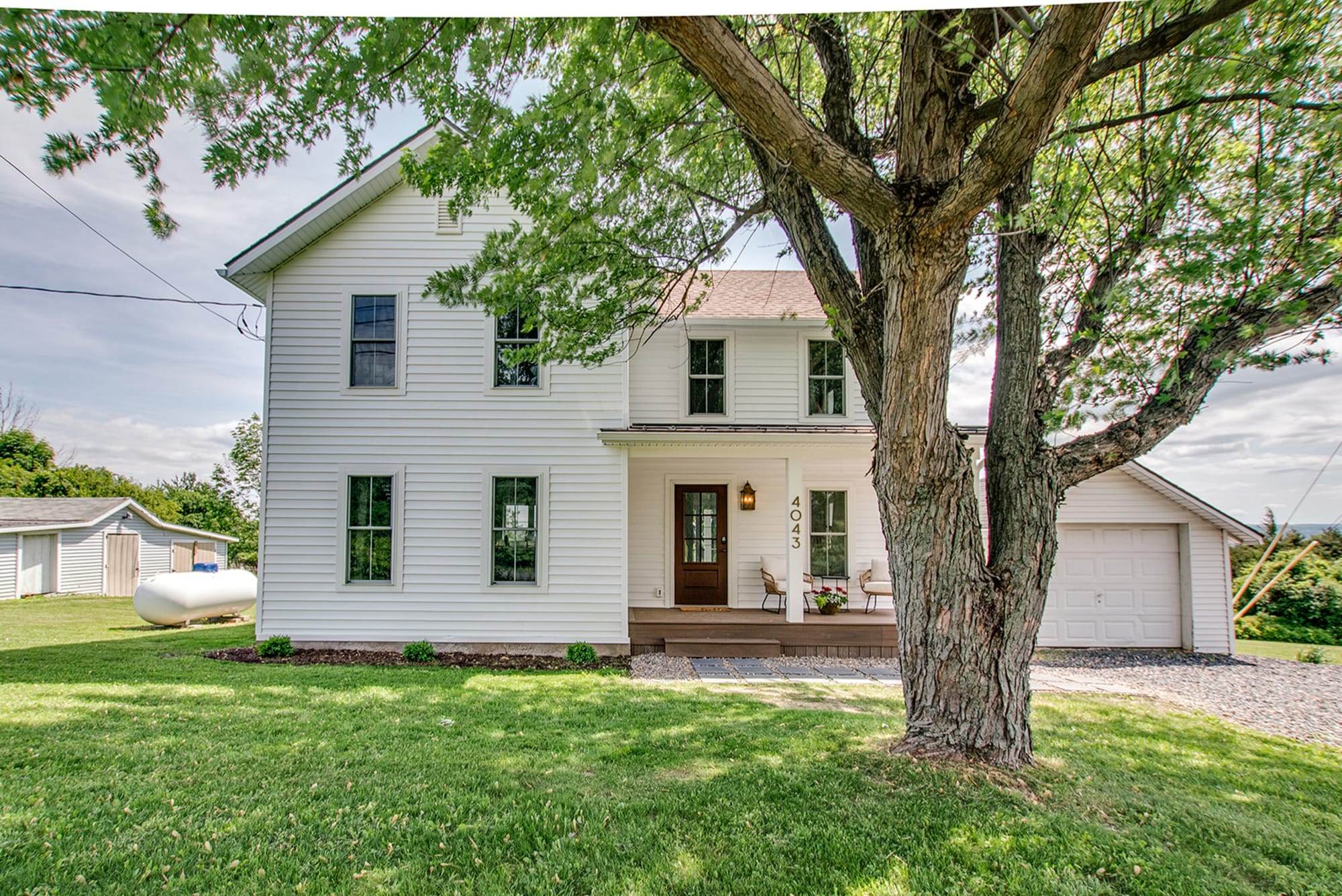 A charming white farmhouse set under a leafy tree, Morning Dove Villa blends small-town comfort with Finger Lakes scenery. Its bright porch and open yard invite you to slow down and enjoy quiet mornings with coffee and birdsong.
