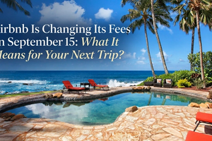 A tropical vacation rental with a private oceanfront pool and palm trees is paired with the headline “Airbnb Is Changing Its Fees on September 15.” The image introduces a travel guide explaining what Airbnb’s fee changes could mean for travelers planning their next vacation.
