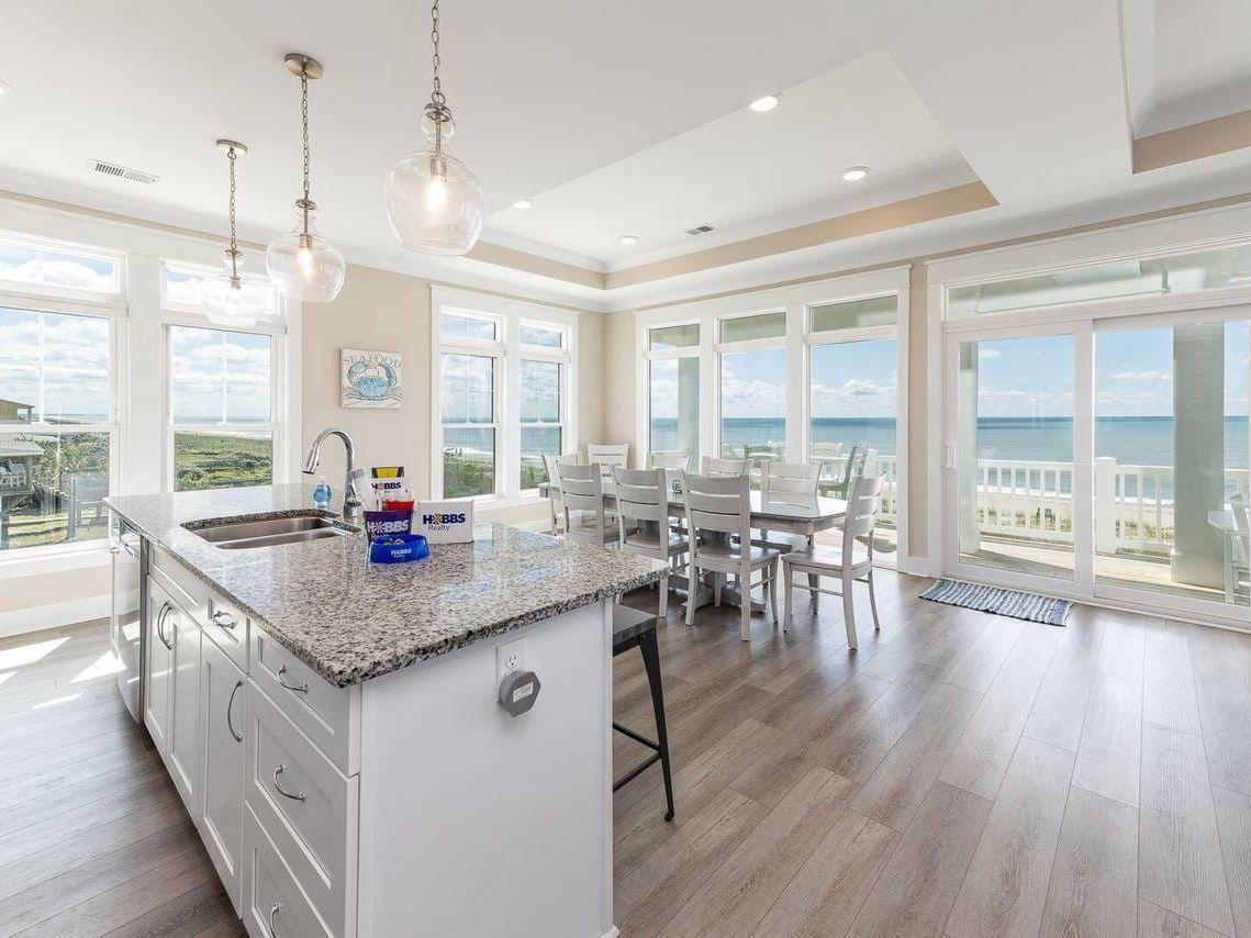 Oceanfront Holden Beach rental with private pool, floor-to-ceiling windows, and an elevated deck offering stunning views. A pet-friendly home designed for relaxation, with direct access to the sand.