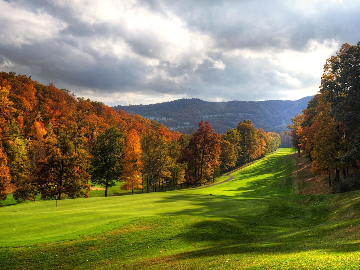 Massanutten Golf Course with mountains in the background surrounded by fall foliage