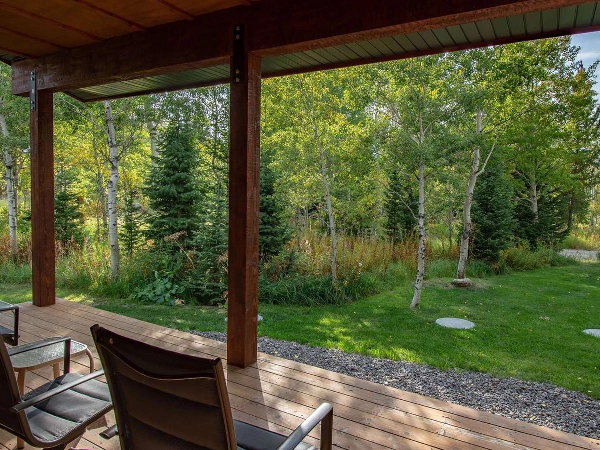 West Yellowstone Vacation Rental Back Deck with Chairs and view of Trees