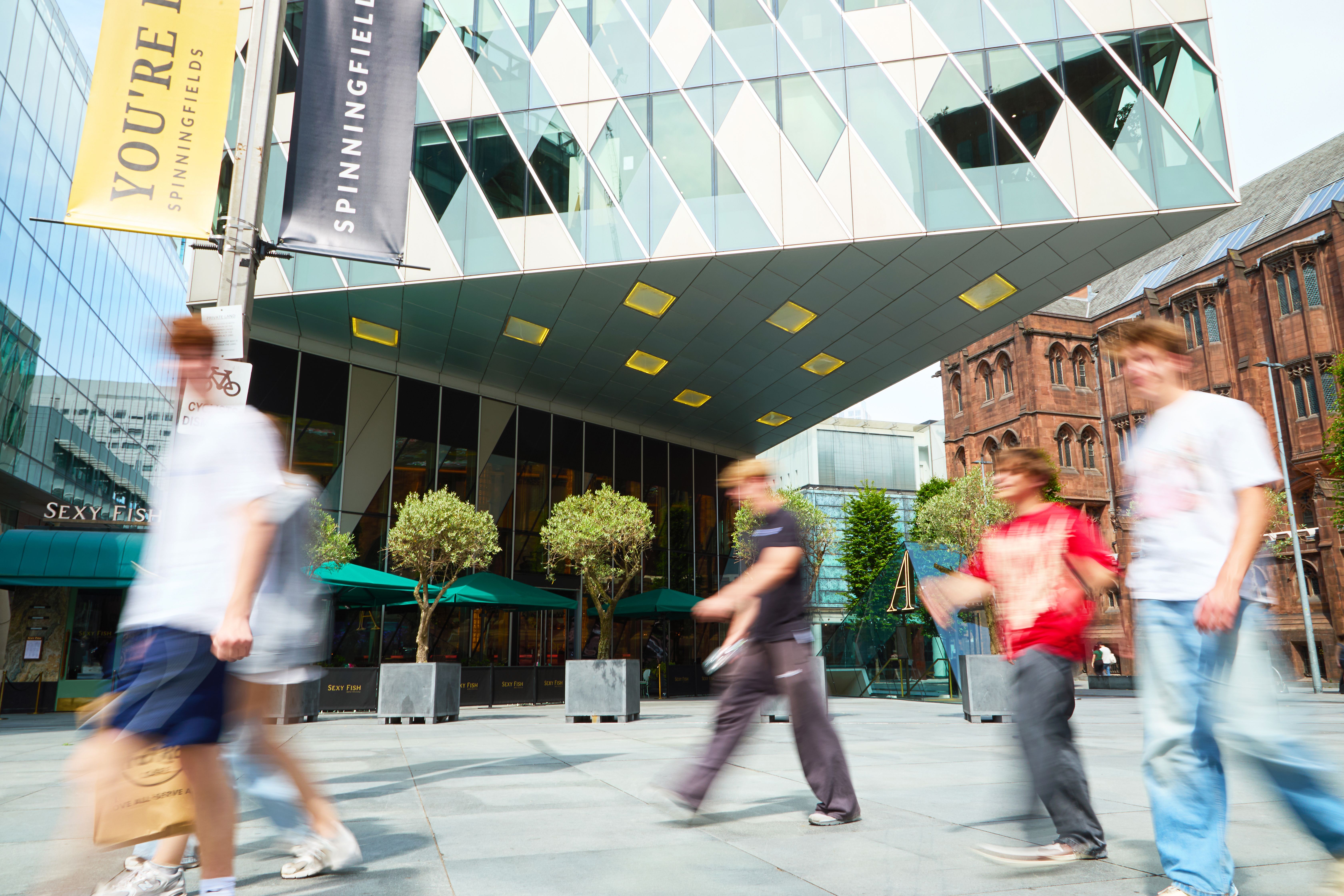 Picture of a group of friends walking through Spinningfields