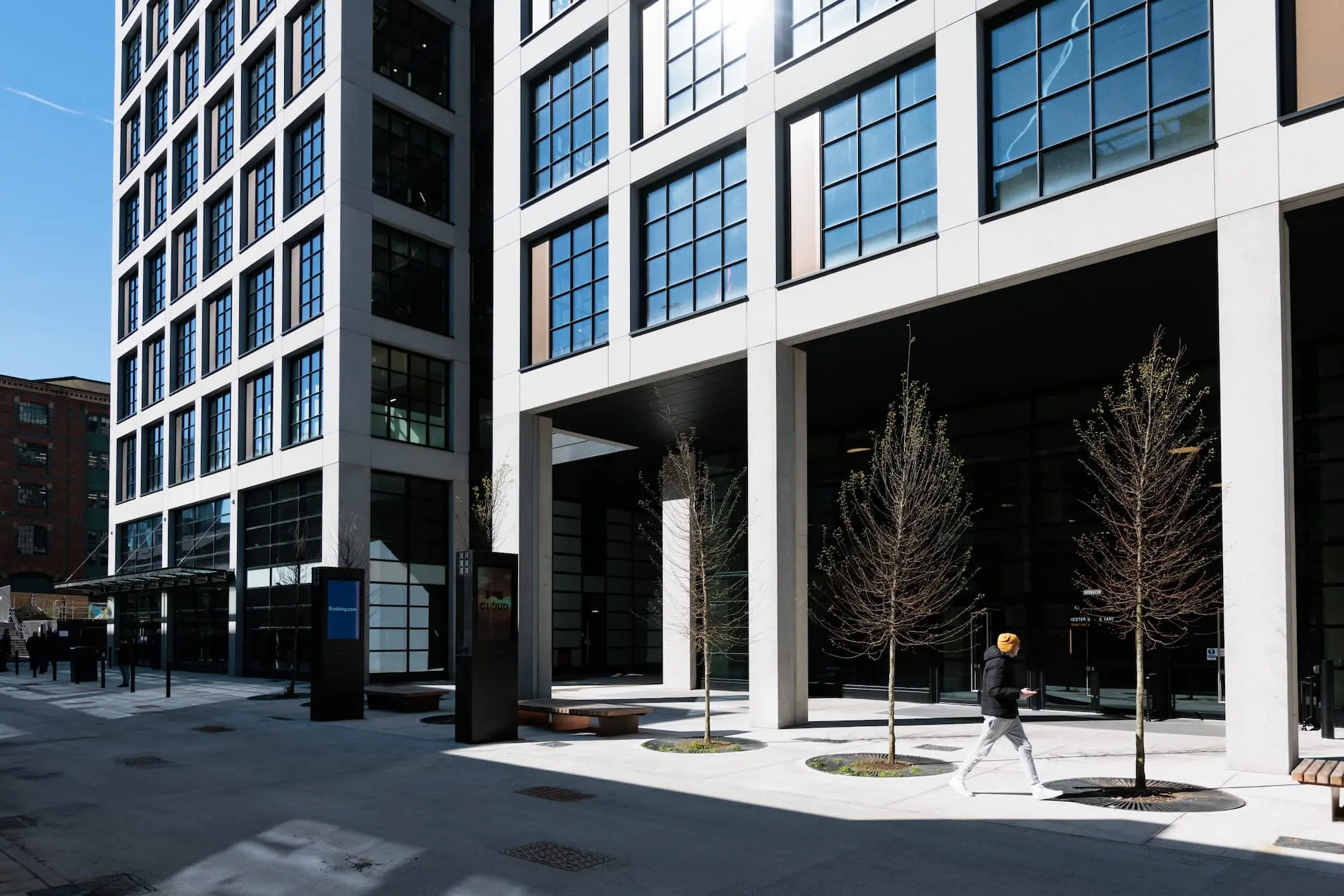 Person walking by modern buildings