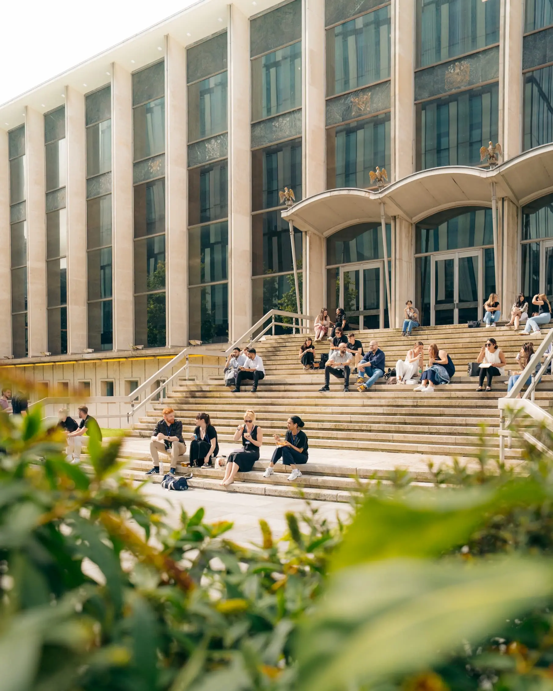People sitting on steps outside Manchester Crown Court