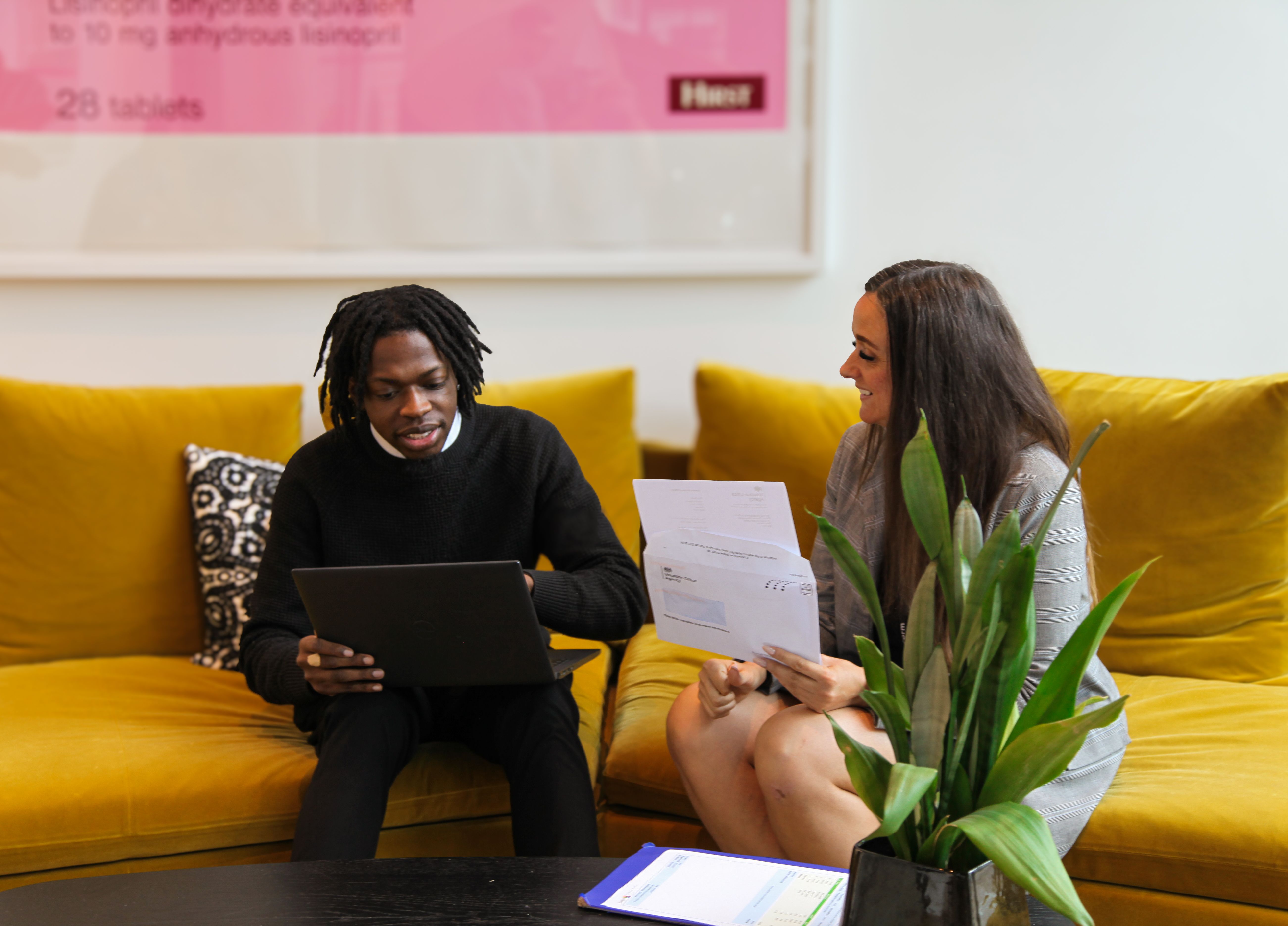 Andrea and Ademola in a meeting