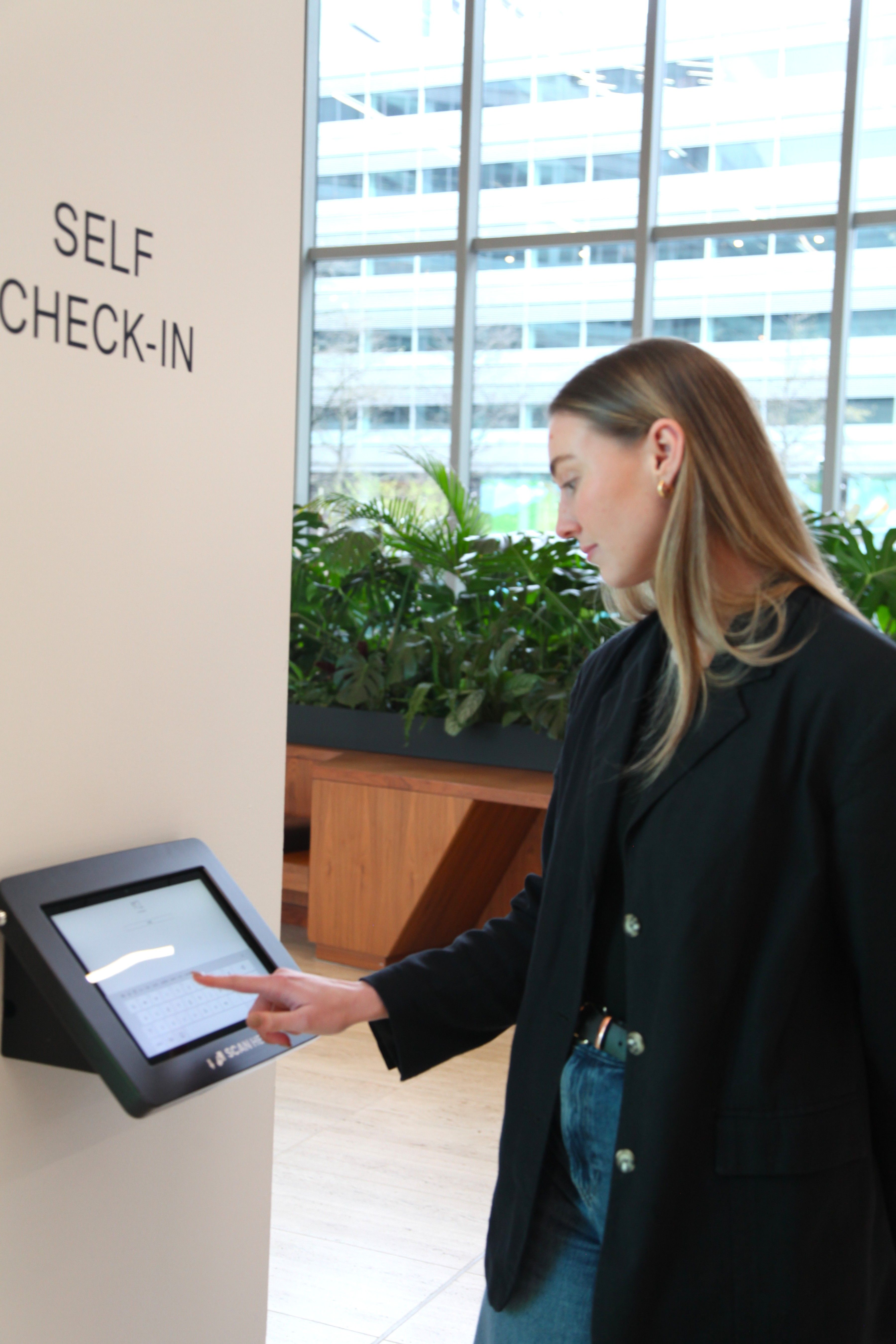 Aoife servicing the Self Check-in Desk