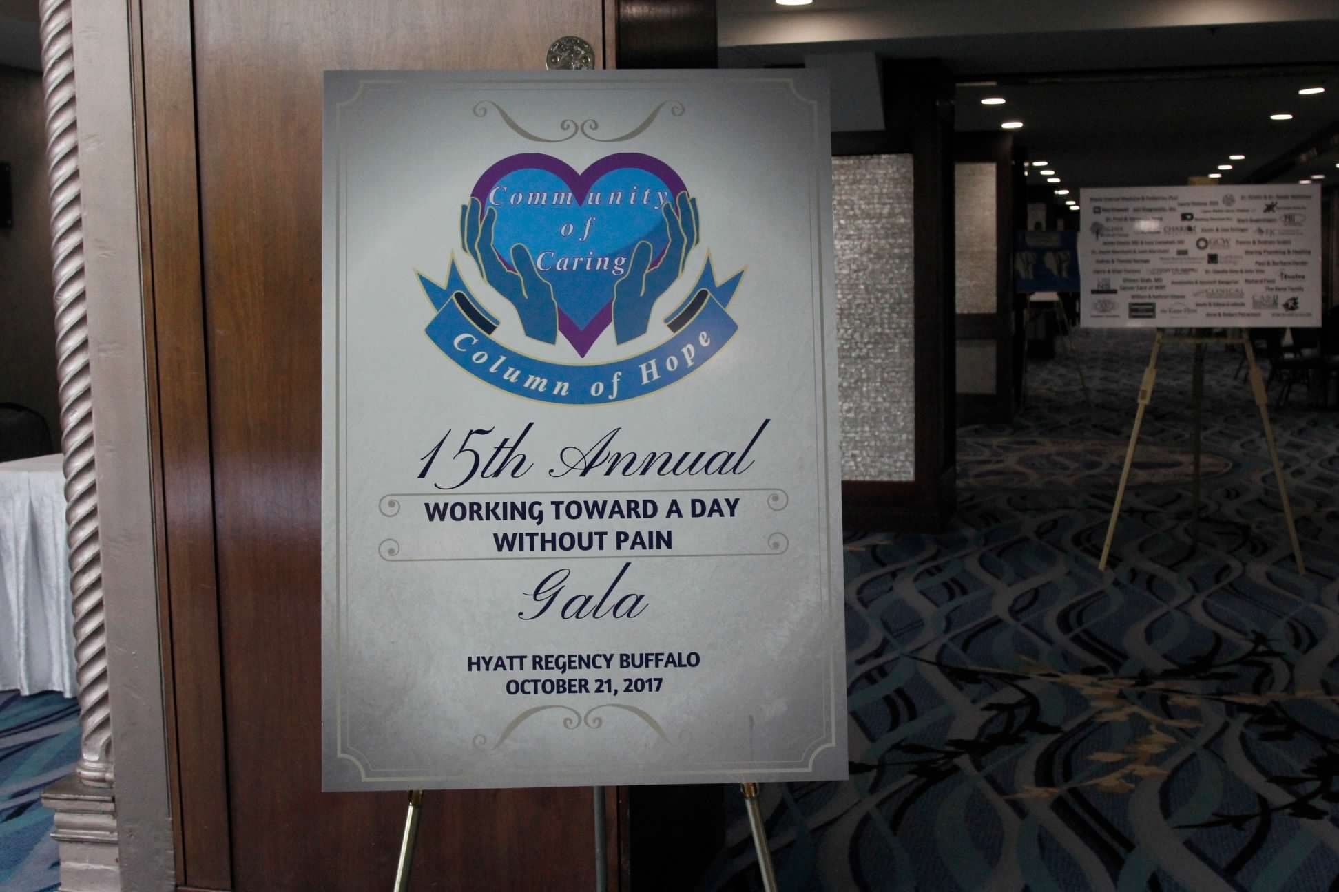 Community of Caring Gala poster, 2017, on its easel at the Hyatt Regency Buffalo