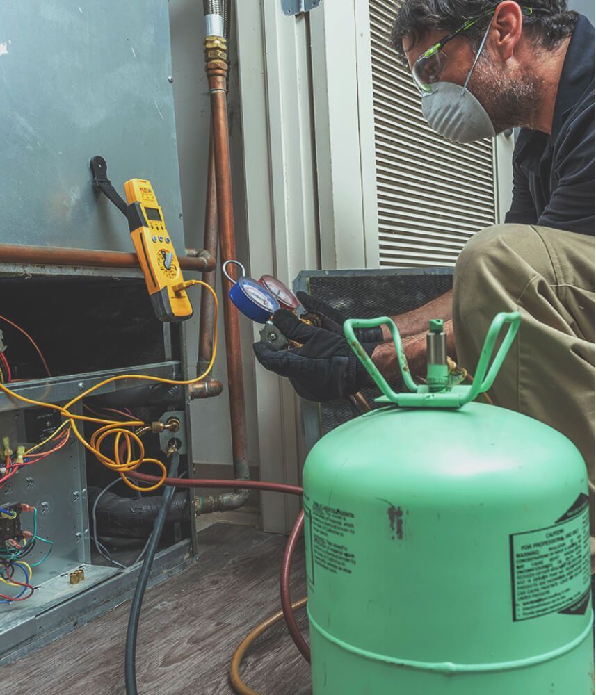 A man checking a gauge from a fuel canister