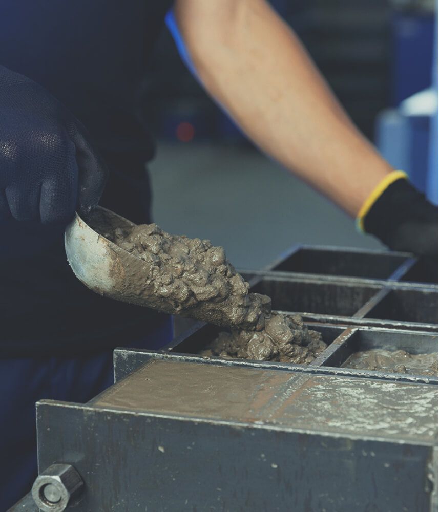 A man using shovelling some mould oil