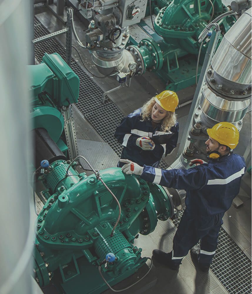 Two people inspecting a gas system