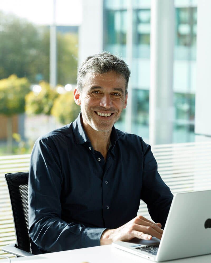 man at computer smiling