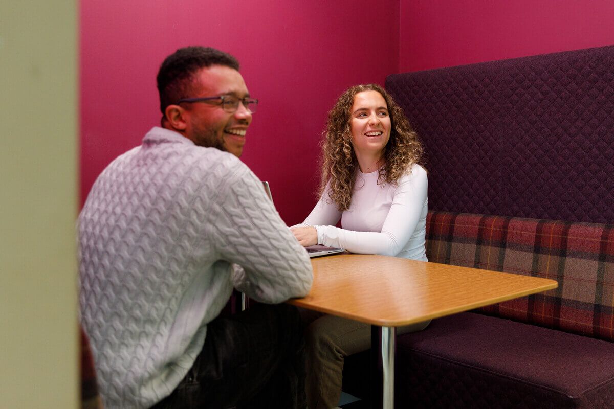 couple at desk smiling