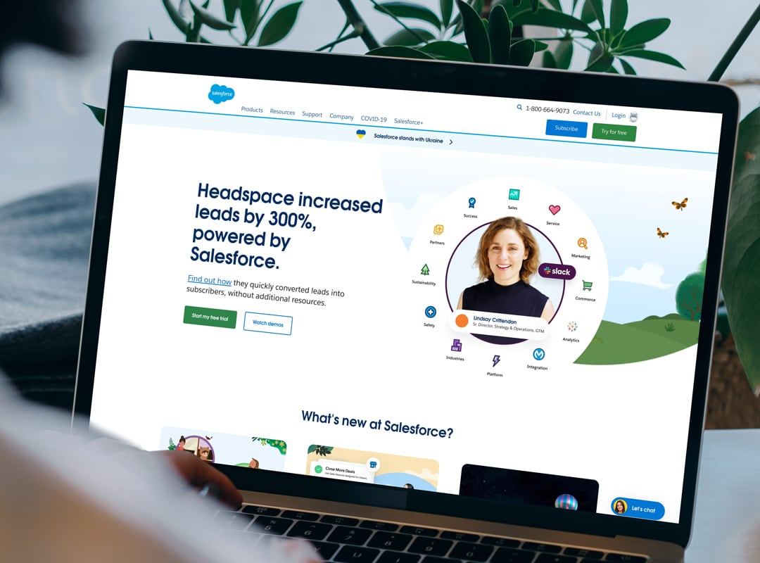 Laptop showing the Salesforce homepage, led by a customer story about Headspace increasing leads by 300%.