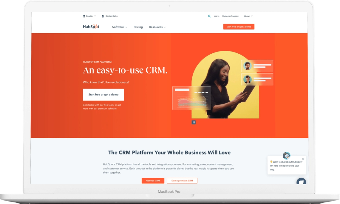HubSpot CRM homepage on a MacBook Pro, with the headline “An easy-to-use CRM” and a free sign-up button.