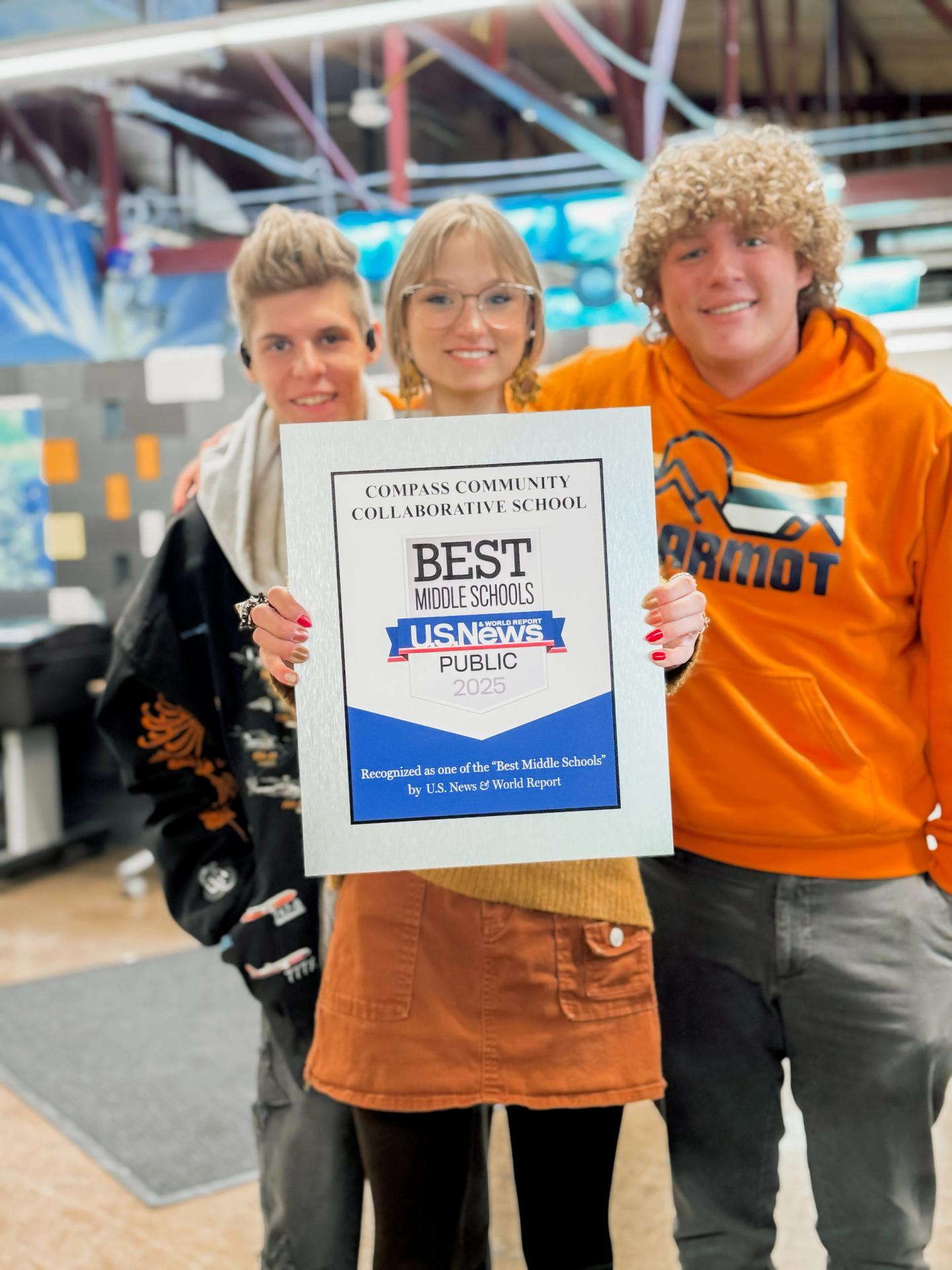 Compass High School Students hold best middle school plaque award