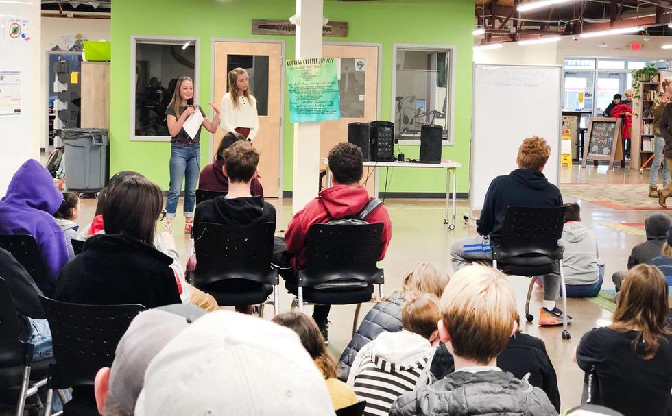 Lucille and Leilani read the Compass Charter aloud to remind students of the school culture we value and protect.