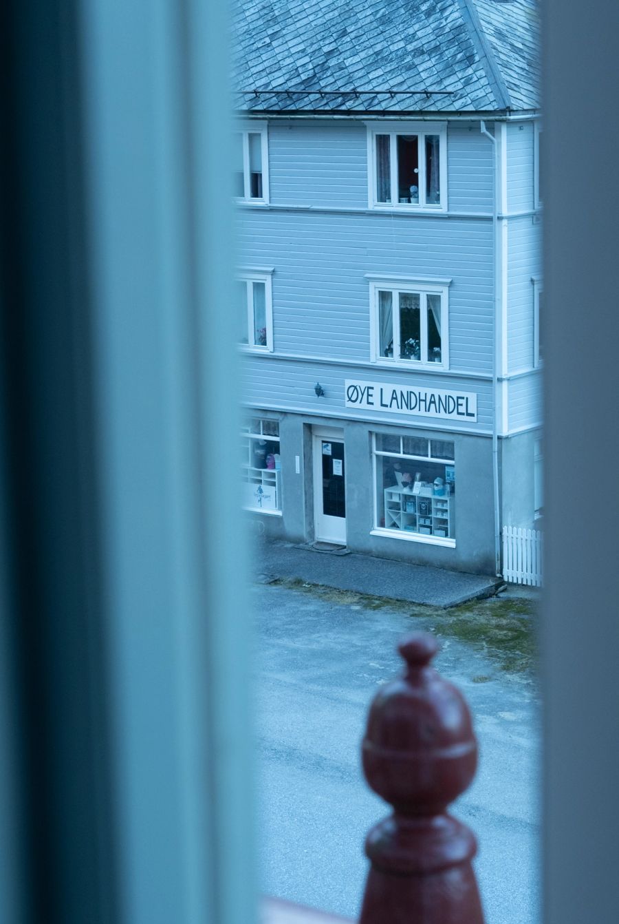 The Øye Landhandel village shop seen through a window in winter light, Norway. Film photograph by Nicolò Pudel