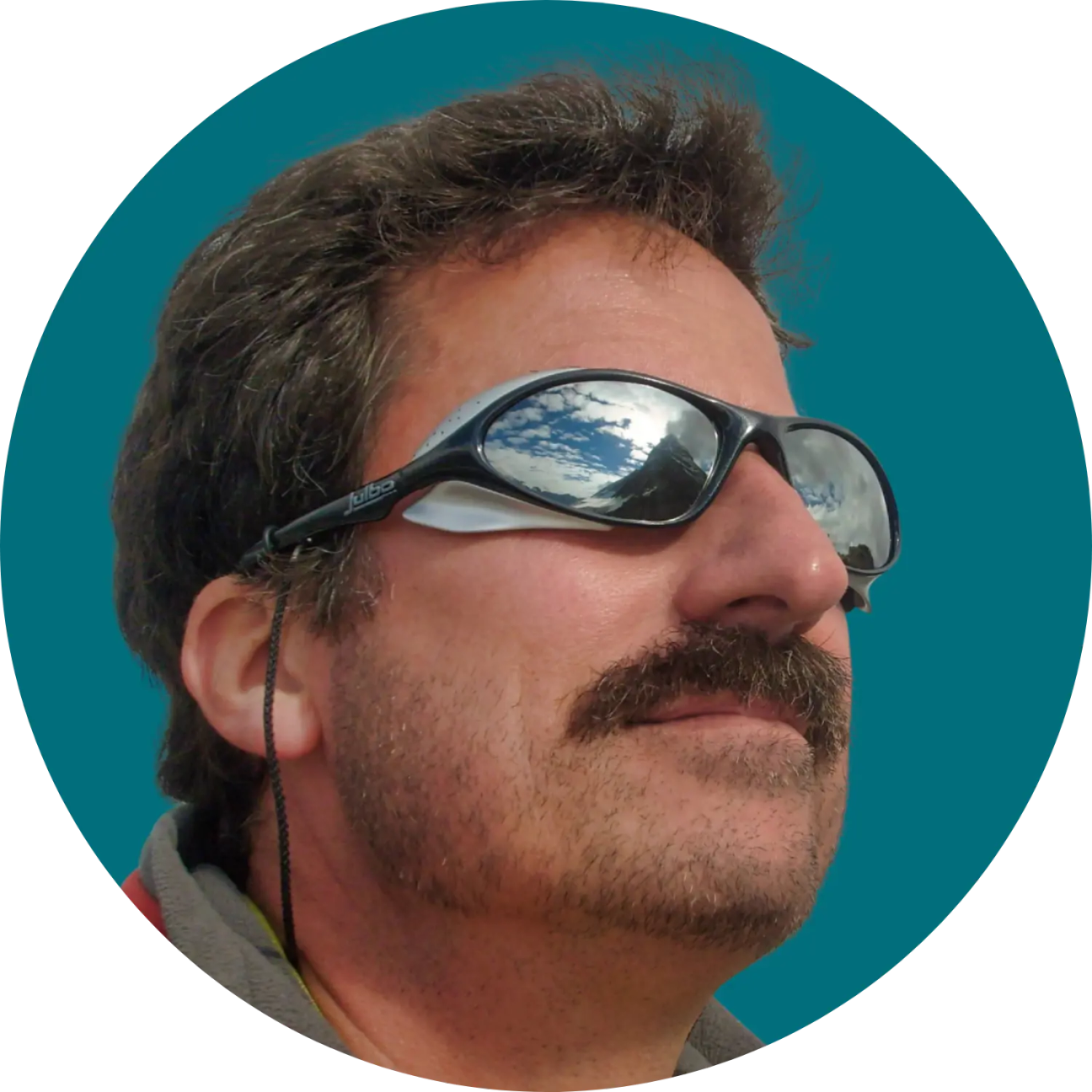 A headshot of Jon Kern against a teal background