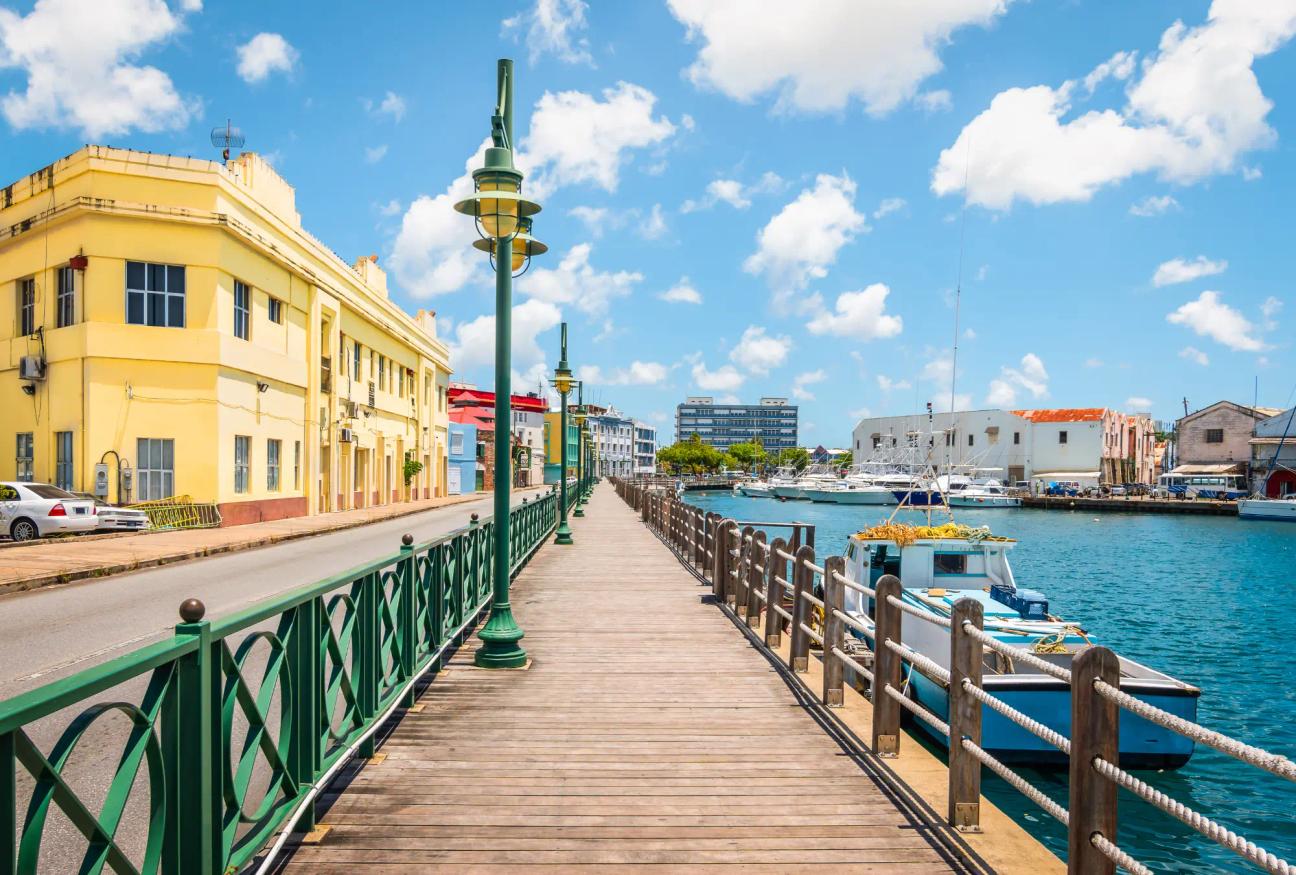 A promenade with sea to the right and Bridgetown's old town to the left