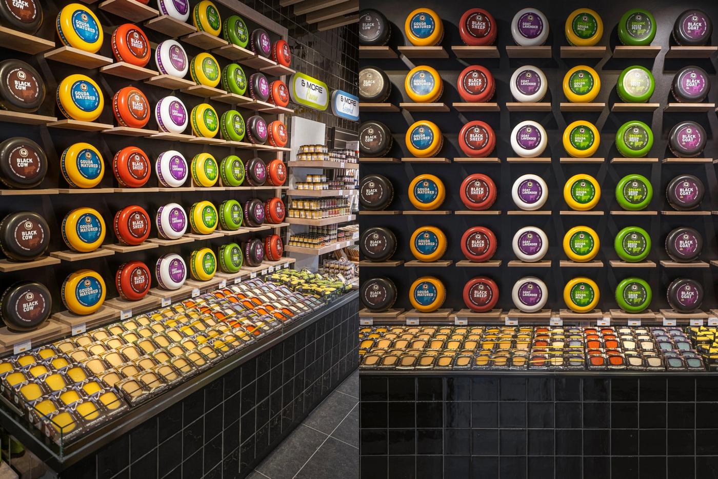 Wand met kaaswielen in de huiskleuren van Cheese & More, met daaronder een toonbank vol verpakte kazen.
