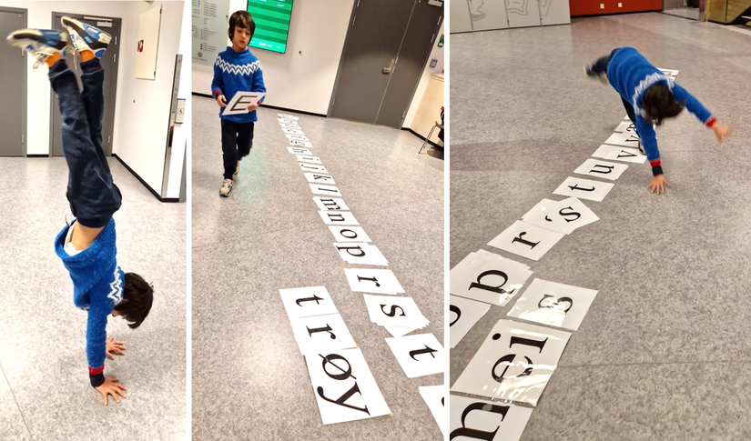 Elev som pusler med store bokstavkort på gulvet