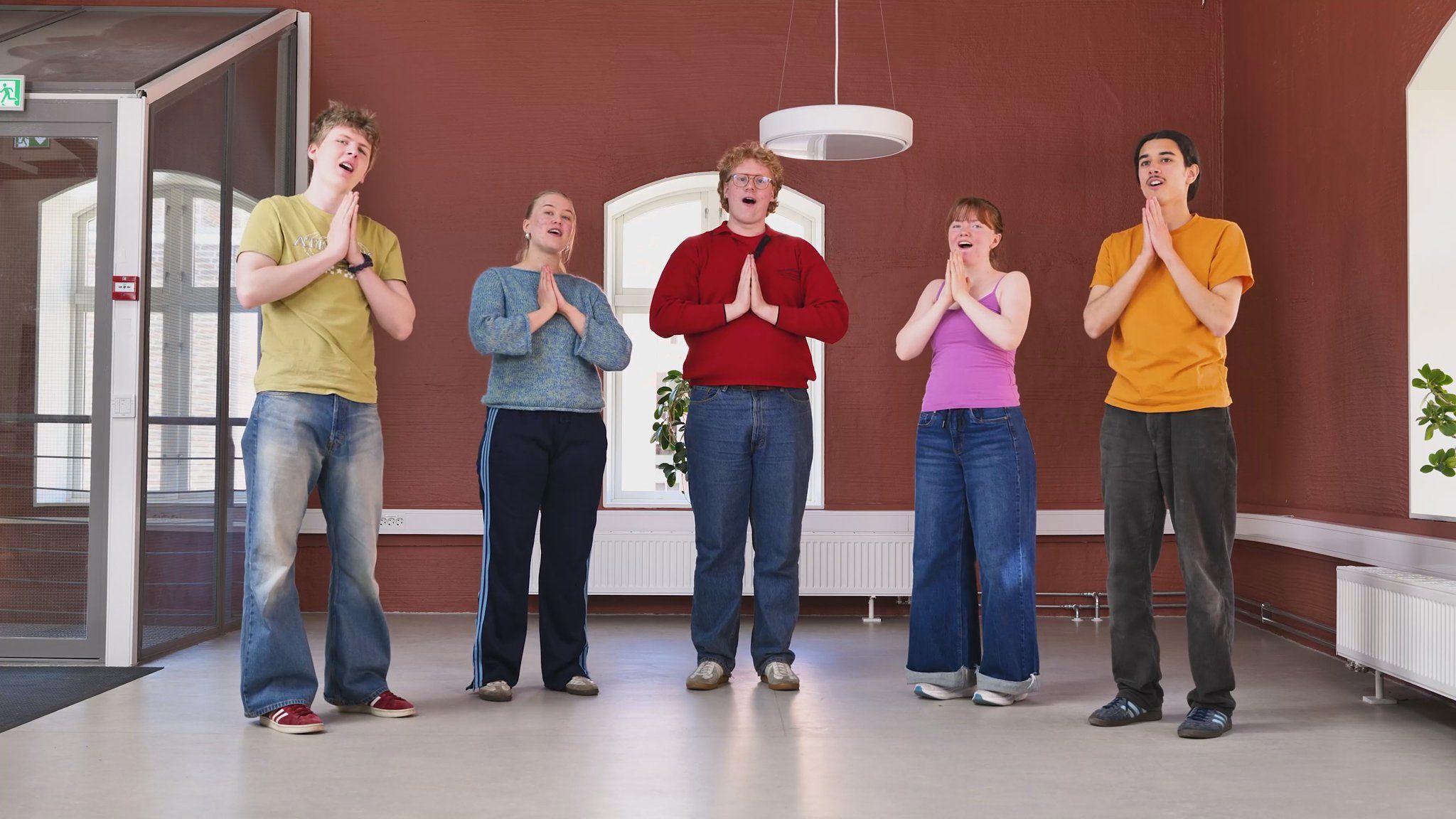 5 ungdommer synger sangen med bevegelser