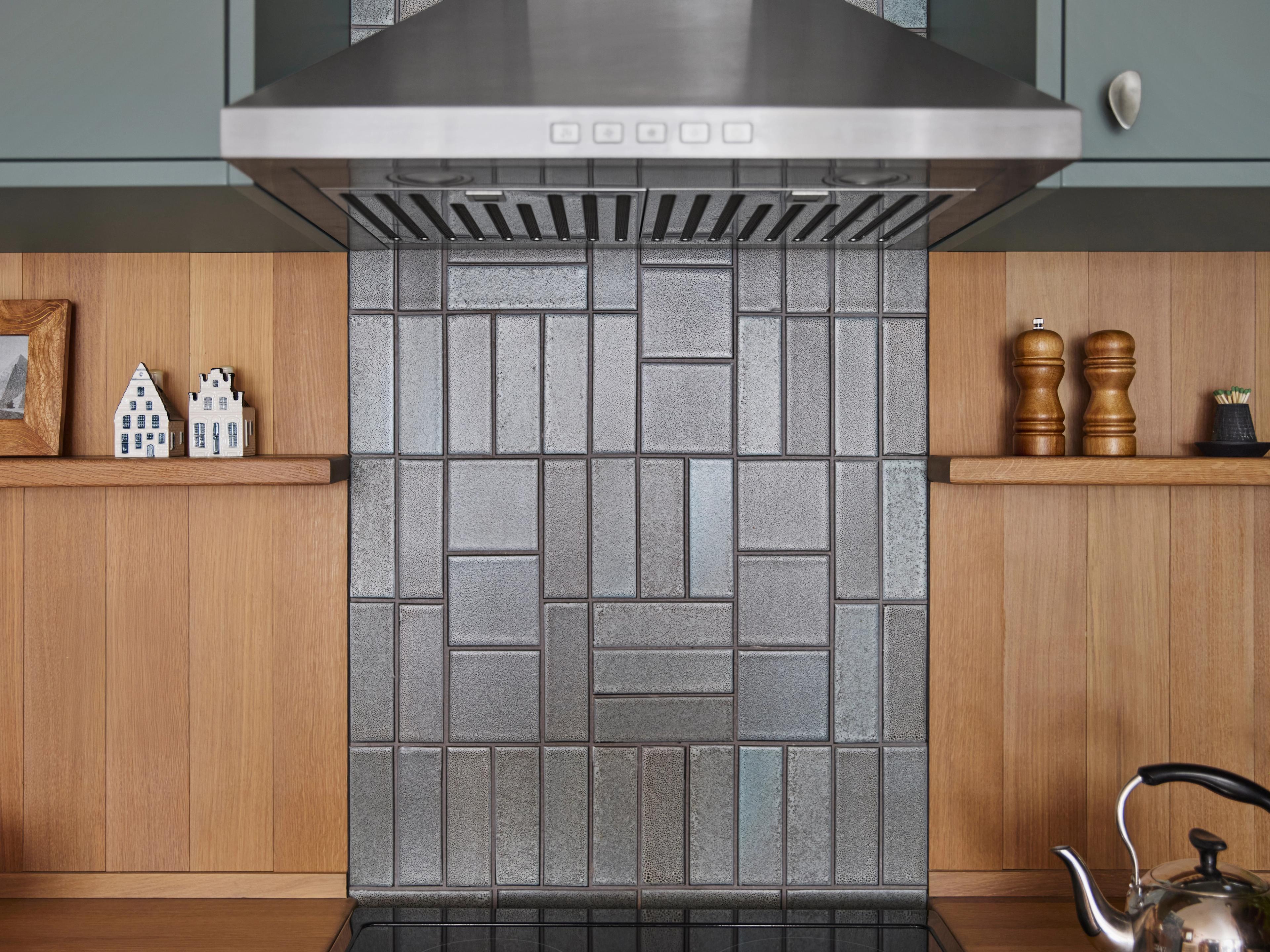 Kitchen range backsplash detail with hand-textured tile in geometric pattern, in Outer Sunset home designed by Studio VAE, San Francisco interior designer.