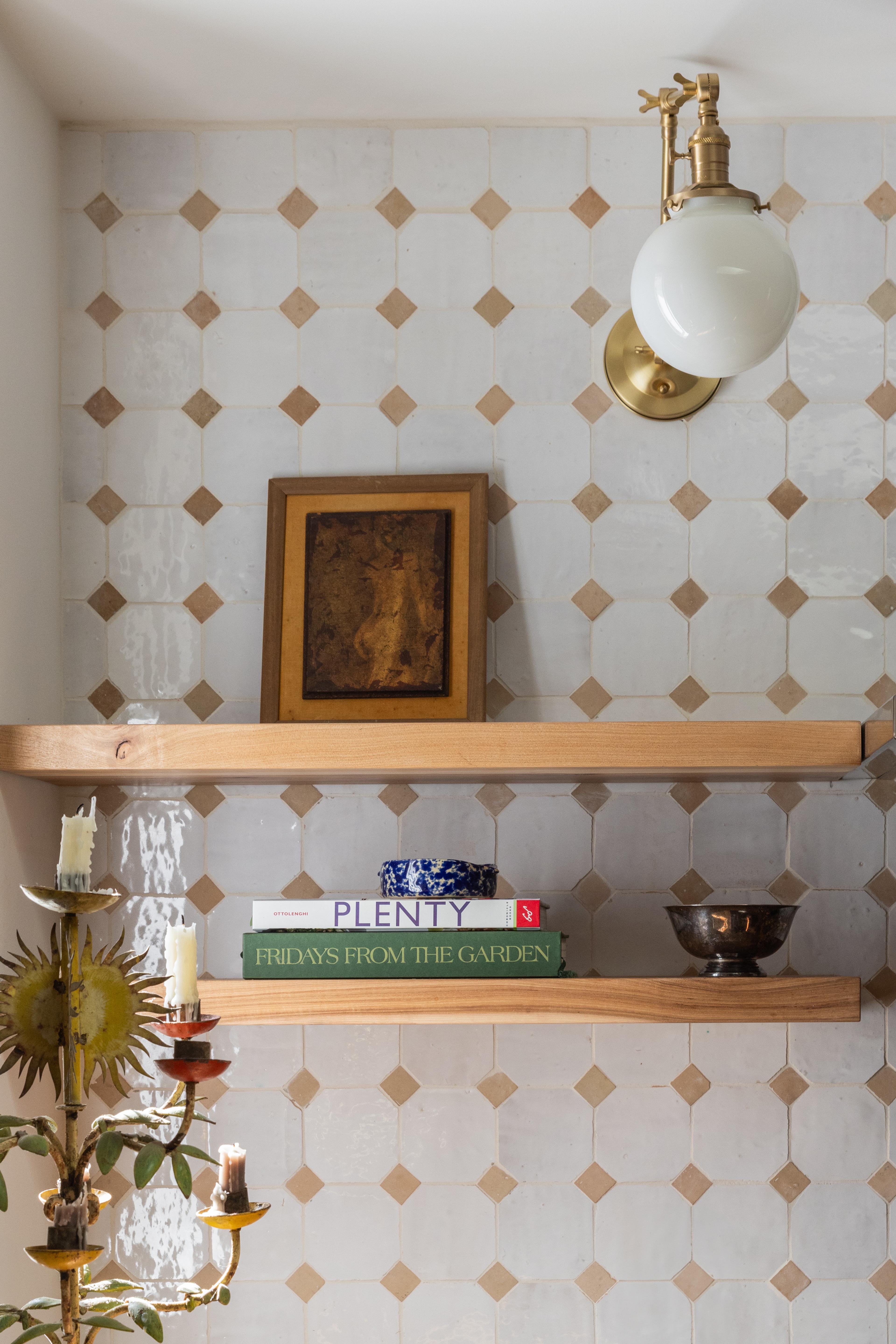 Kitchen open shelving against handmade zellige tile in diamond pattern with brass globe sconce in Carmichael home designed by Studio VAE, San Francisco interior designer.