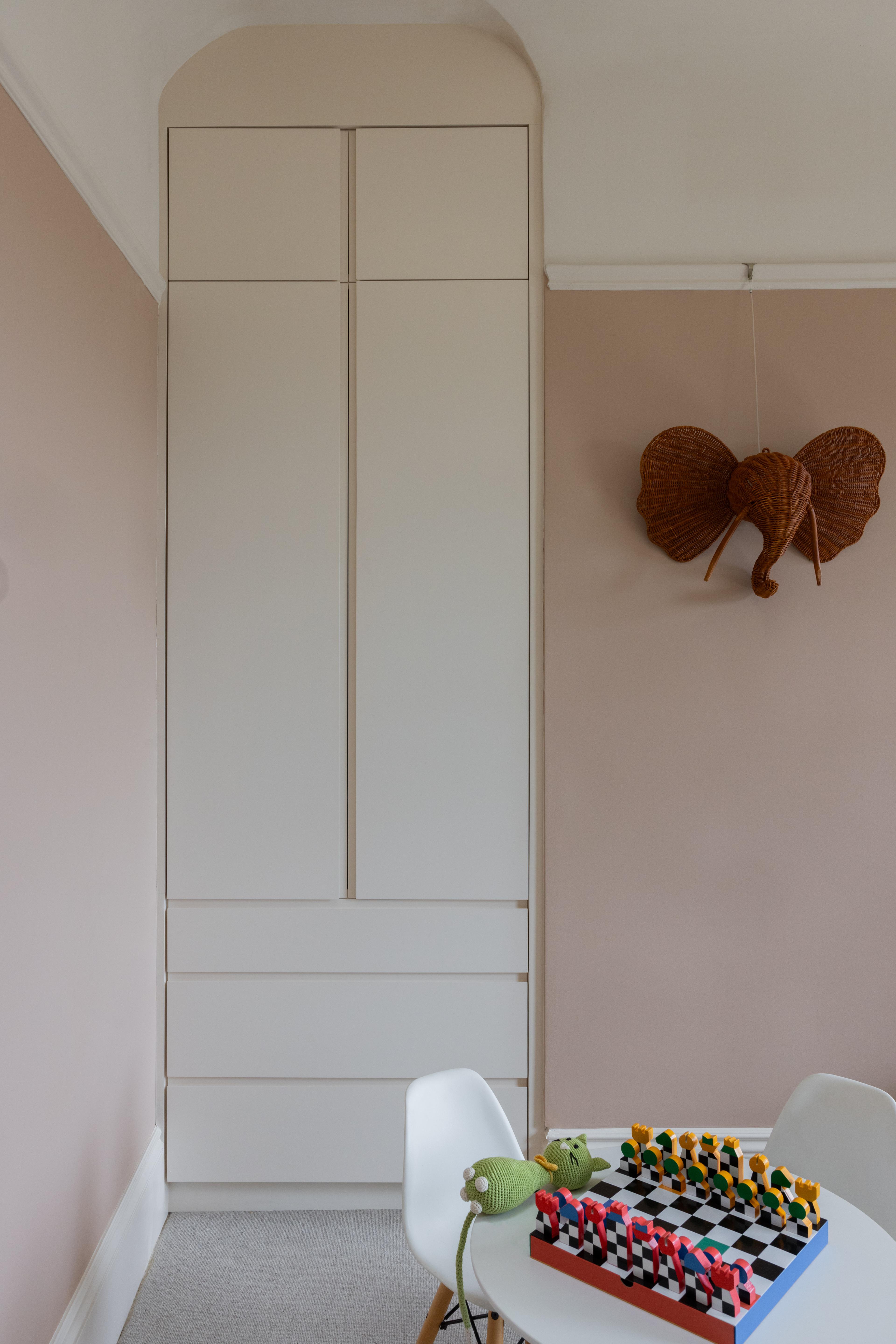 Children’s bedroom with custom built-in wardrobe and arched detail tucked into an alcove, designed by Studio VAE, San Francisco interior designer.