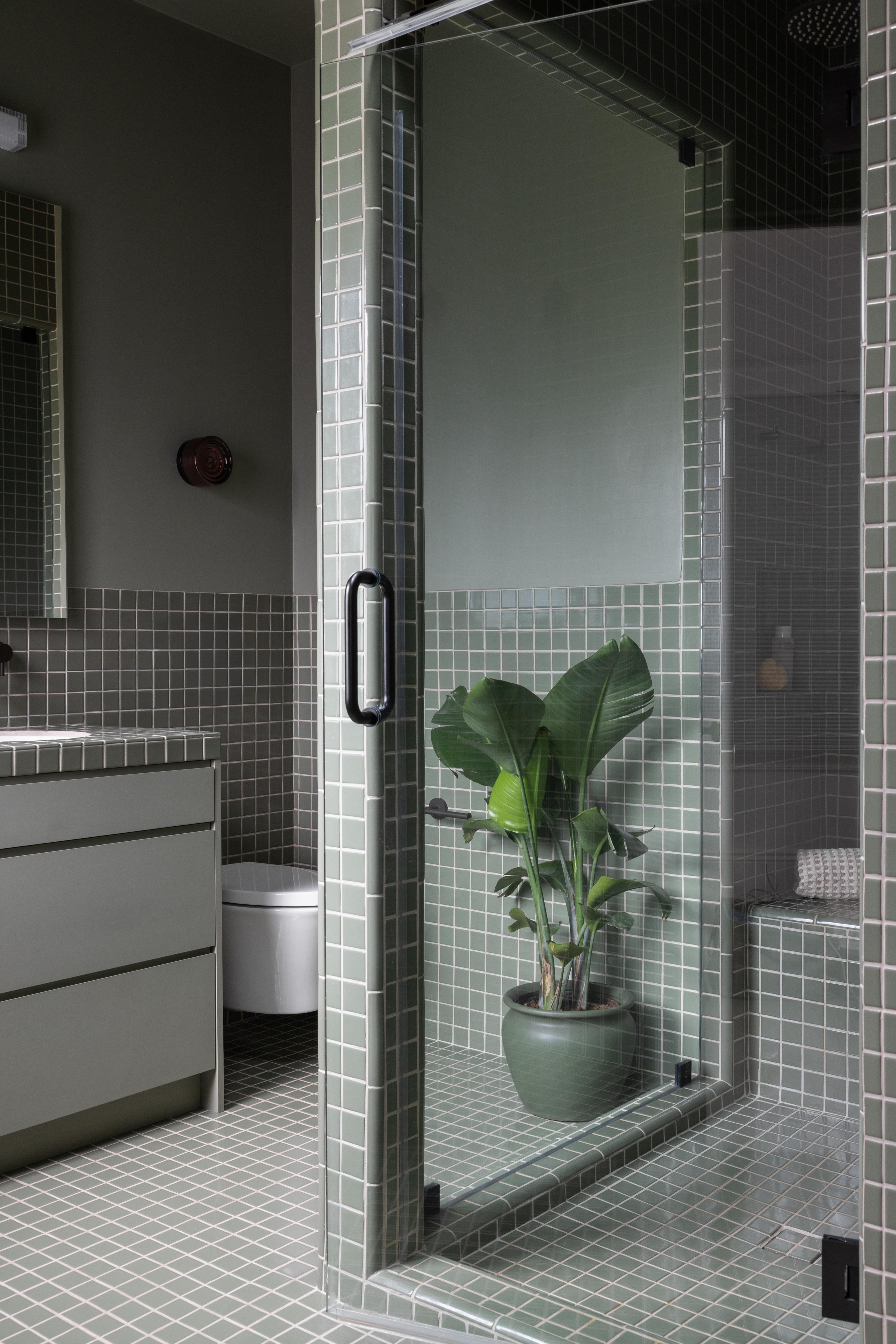 Primary bathroom with green grid tile, steam shower, and tonal painted vanity designed by Studio VAE, San Francisco interior designer.