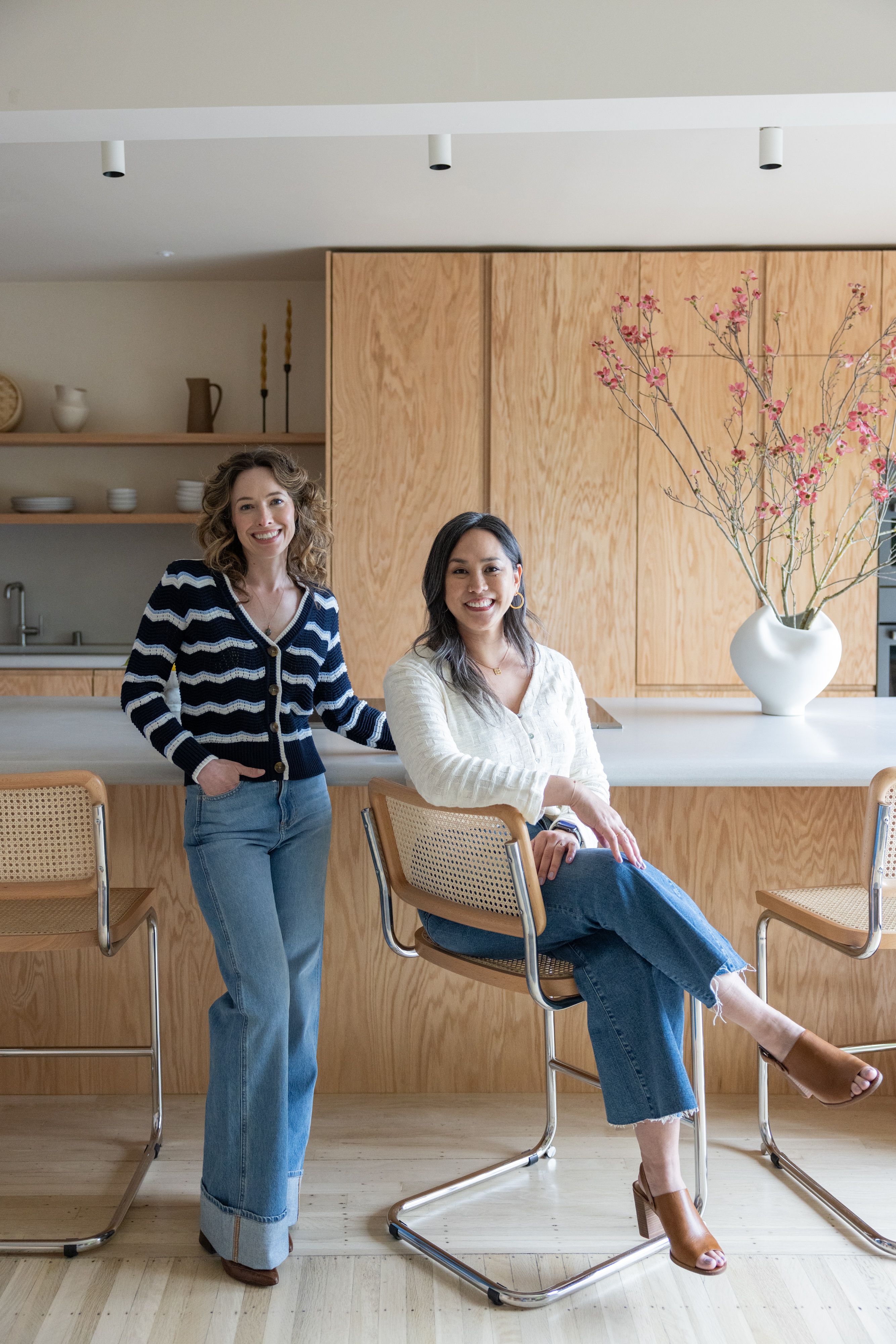 Studio VAE principals Veronica Jurist and Aggie Revane in a red oak kitchen in San Francisco
