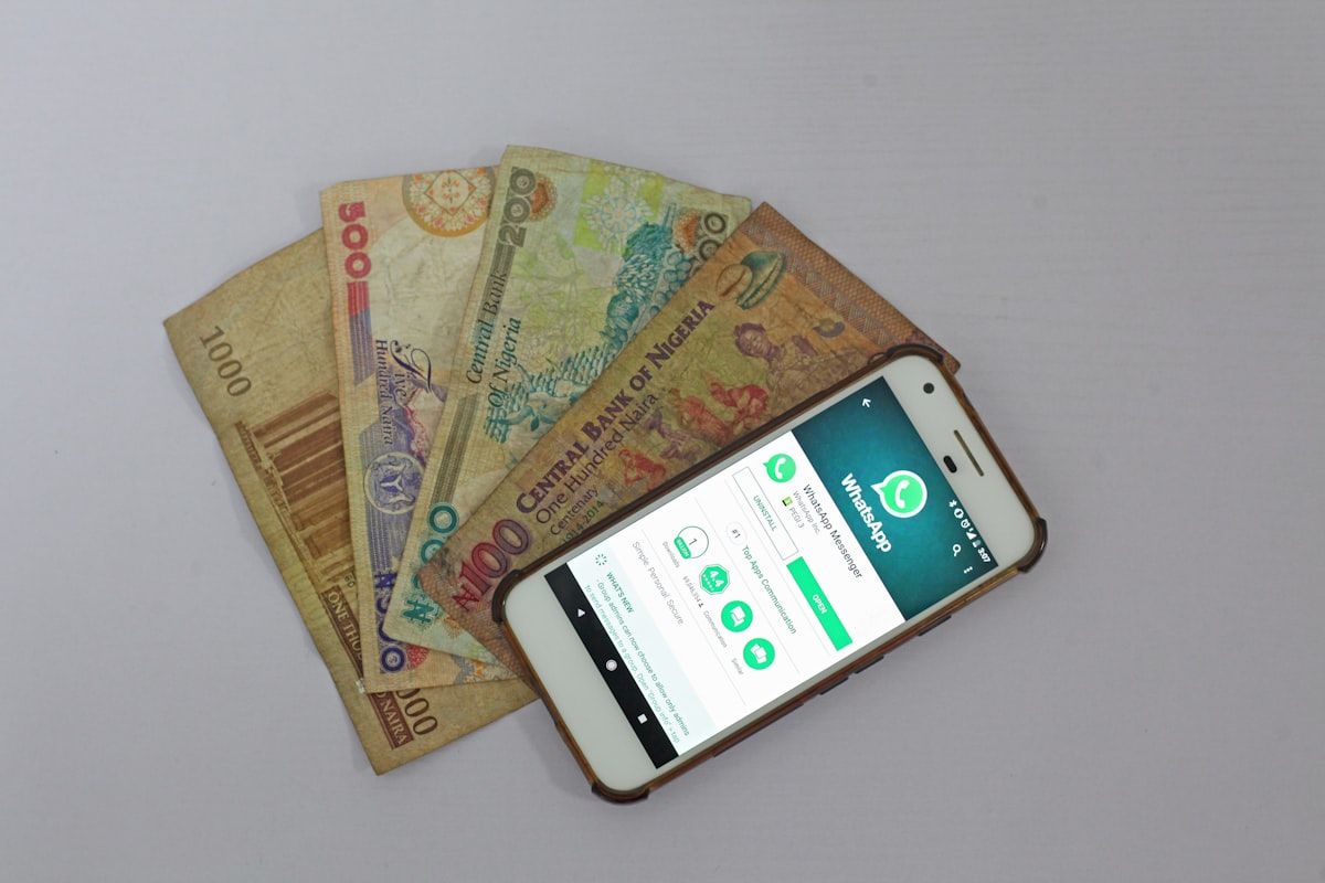 Smartphone beside banknotes demonstrating mobile payment technology