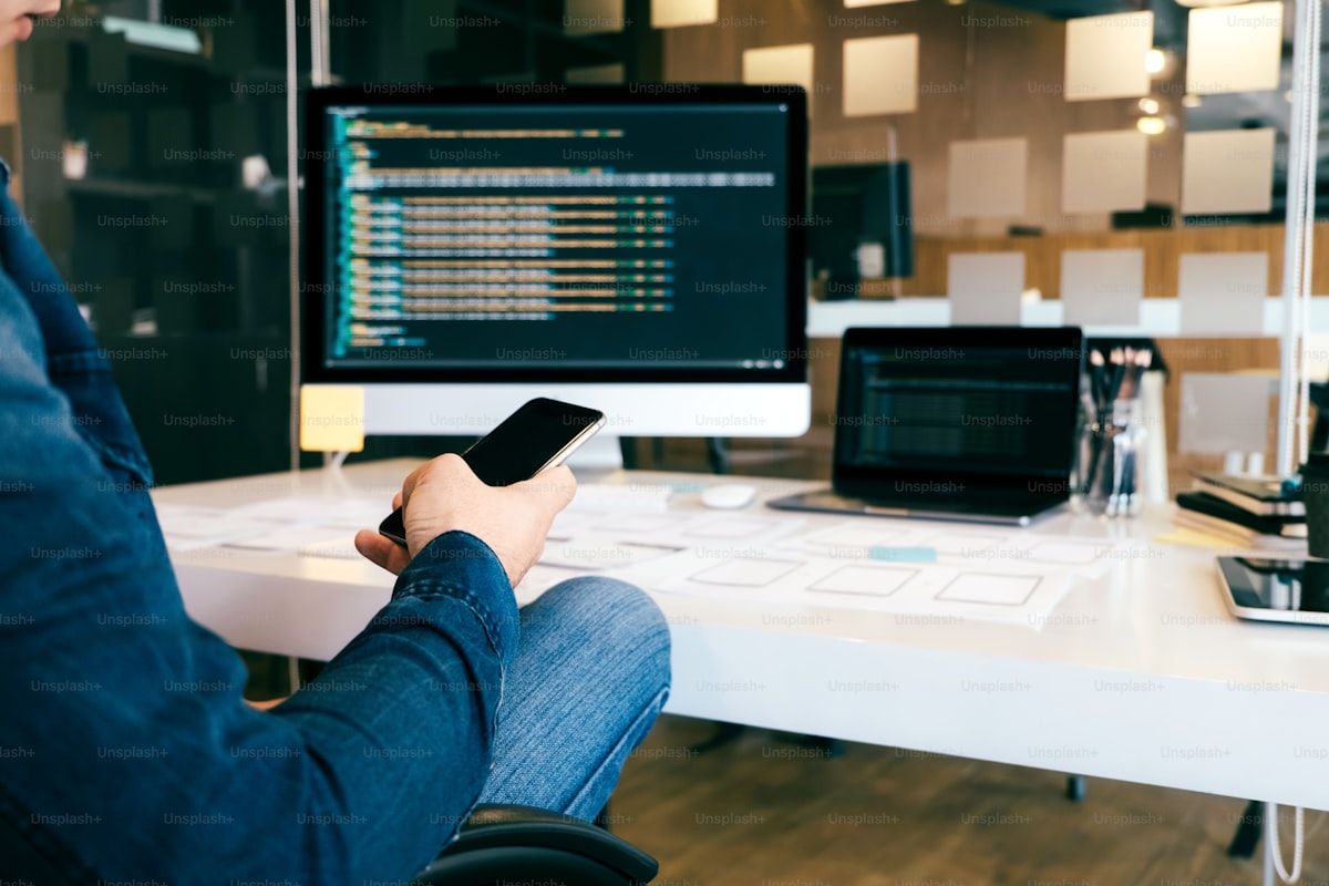 Programmer and UX designer working together in a software development environment