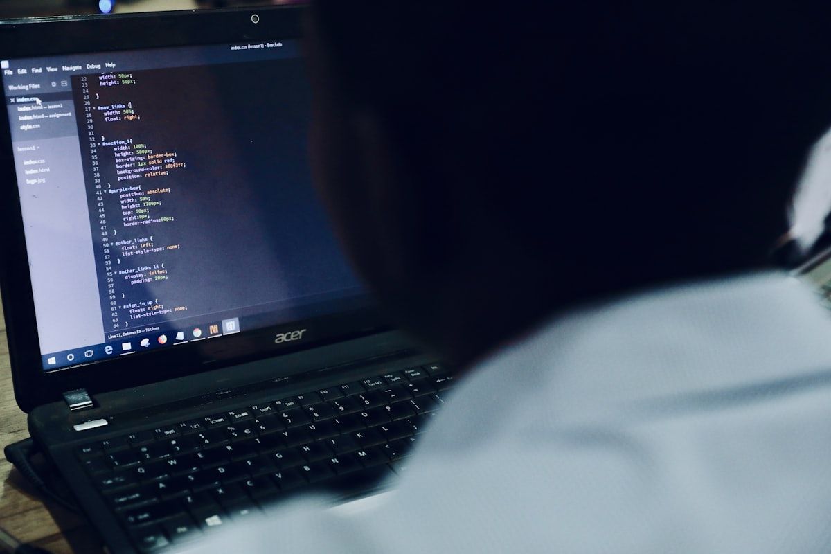 Close-up of a laptop screen showing code in a developer workspace
