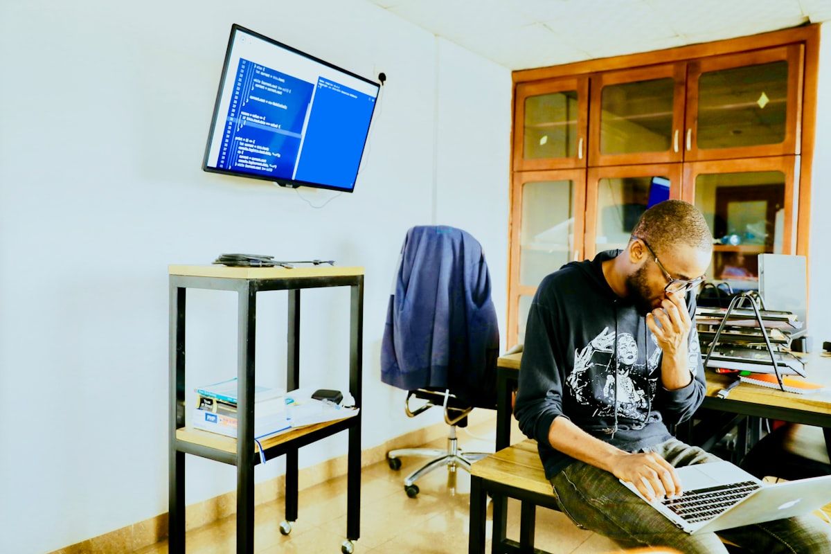 African software developer working on a laptop in a modern workspace