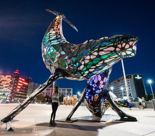 Woman looking at the space whale statue in downtown Reno