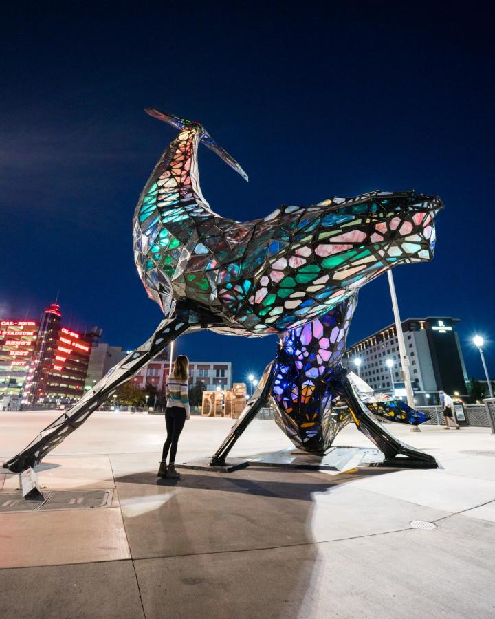 Woman looking at the space whale statue in downtown Reno