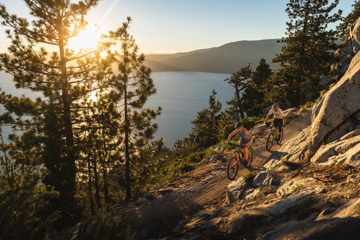 Bike riding down a trail with a view of Lake Tahoe