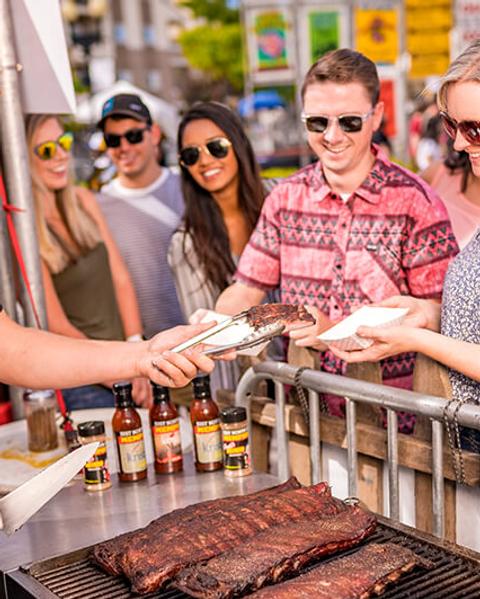 Woman purchasing ribs at the Nugget Rib Cook Off