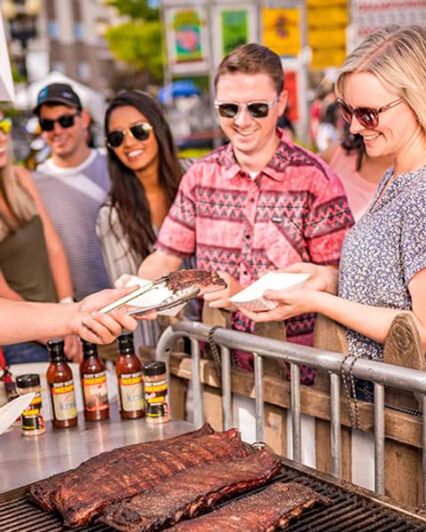 Woman purchasing ribs at the Nugget Rib Cook Off